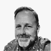 A friendly, bearded man with a warm smile, wearing a patterned shirt conveys the approachable spirit of Birdie.