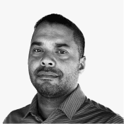 A professional man with a short beard and dark hair gazes forward, embodying the focused expertise Birdie offers.