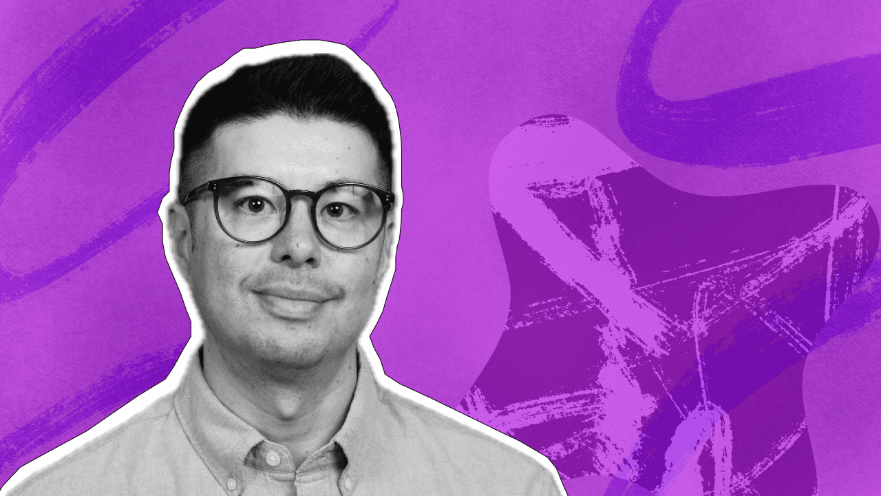 A smiling man in round glasses, rendered in grayscale, against a vibrant purple background with abstract brushstrokes.